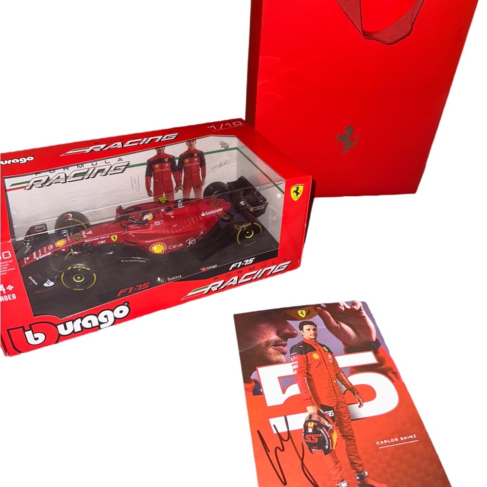 Formula 1 Carlos Sainz 1:18th scale Burago toy car
with card signed from Carlos